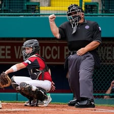 An umpire officiating a Little League baseball game