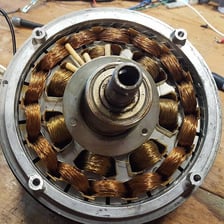 An electric motor is visible inside a ceiling fan housing.