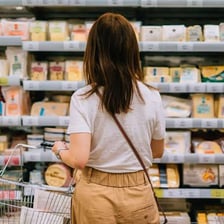 A shopper selecting groceries in a supermarket