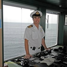 A sailor aboard a ship responding to an order.
