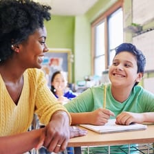 A group of students of different genders in a classroom