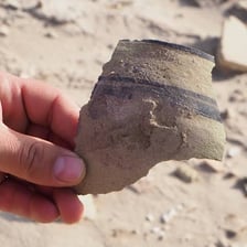 Scattered fragments of broken pottery
