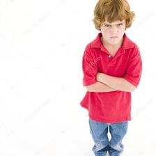 A person standing with crossed arms in a defiant pose