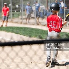A baseball batter approaching home plate