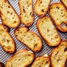 A French baguette sliced into rounds for crostini.