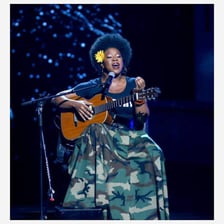 Singer India.Arie performing with an acoustic guitar