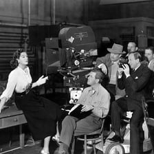 A film performer standing on a movie set.