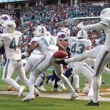 An American football player punting the ball during a game
