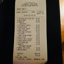 A person paying a restaurant bill for a group of diners