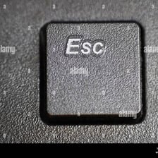 A close-up of a keyboard shows its Esc key.