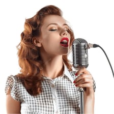A singer performing with an open, projected voice.