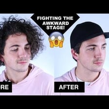 A person wears a hat over unruly hair.