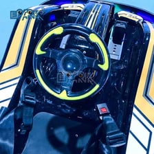 The steering wheel and controls inside an amusement-park bumper car.