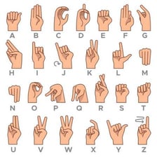 A person communicating with hand signs in American Sign Language.