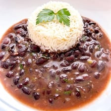 A serving of Brazilian feijoada accompanied by white rice.
