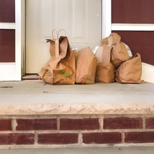A delivered dinner order being handed to a customer