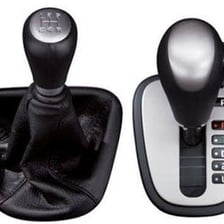 A car interior showing an automatic gear selector beside an illustration of a manual shifter.