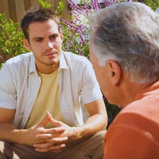 Two people in conversation as one asks for confirmation of what was heard