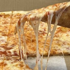 A pizza topped with an abundant layer of melted cheese.