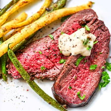 Béarnaise sauce served over a grilled steak