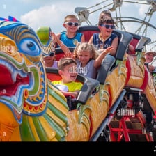 A delighted child laughing while riding an amusement-park attraction.