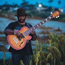 Thundercat and Paul McCartney performing with bass guitars.