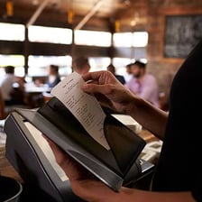 A restaurant meal shown with a complimentary notation on the bill