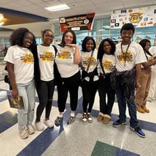 A group of high school seniors celebrating together.