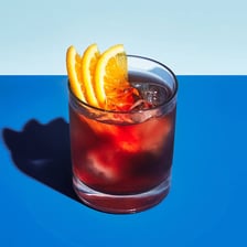 A Negroni cocktail served in a glass with its traditional ingredients.