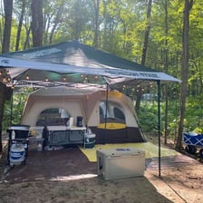 A fabric tent pitched at a campsite