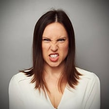 An angry person with a visibly frustrated expression.