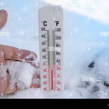 A snowy winter scene with a thermometer showing a temperature in the teens.