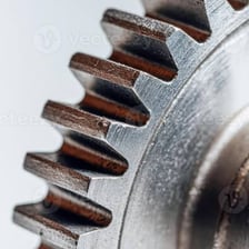 A mechanical gear with visible cog teeth.