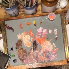 Thick oil paints arranged on an artist’s palette
