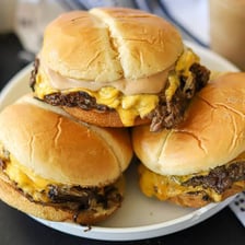 A smashburger served on a plate.