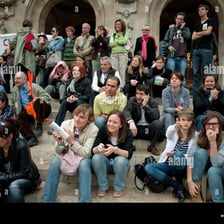 A crowd gathered during a noisy public commotion.