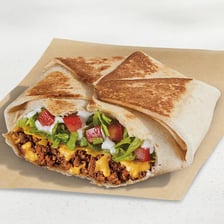 A Taco Bell Crunchwrap Supreme wrapped in its packaging