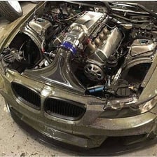 A visible V8 engine with its cylinder banks and components