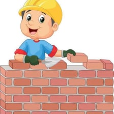 A mason laying bricks with mortar.