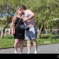 A couple kissing outdoors as a public display of affection