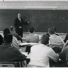 An instructor teaching students in a university classroom.