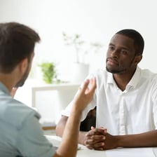 A person listening attentively to another speaker.