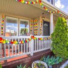 A colorful flower lei arranged as a garland.
