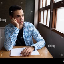 A person looking listless while gazing out a window
