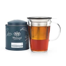 A cup of Earl Grey tea beside a tea container.