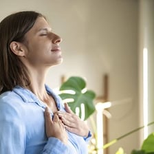 A person visibly relaxing and exhaling after a stressful moment