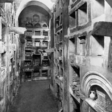 An underground catacomb corridor with burial chambers