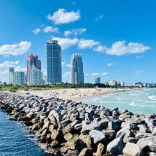 The Miami skyline beside a Florida beach.