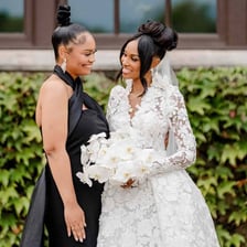 A maid of honor standing beside a bride during a wedding ceremony.