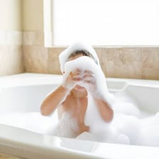A bathtub filled with foamy bubble bath.